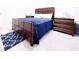 Bedroom with dark wood furniture, a blue comforter, and a navy patterned area rug at 5175 Bridle Point Pkwy, Snellville, GA 30039