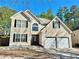 Charming two-story home with a two car garage and a well-manicured front yard at 5175 Bridle Point Pkwy, Snellville, GA 30039