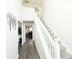 Bright hallway featuring hardwood floors and a staircase with gray carpet and white railing at 5175 Bridle Point Pkwy, Snellville, GA 30039
