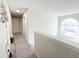 Upstairs hallway with carpet, an arched window, and a view of the lower level at 5175 Bridle Point Pkwy, Snellville, GA 30039