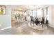 Open concept kitchen and dining area with white cabinets, granite counters, stainless steel appliances, and wood floors at 5175 Bridle Point Pkwy, Snellville, GA 30039