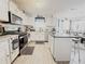 This kitchen has white cabinets, granite countertops, stainless steel appliances, and an island with bar seating at 5175 Bridle Point Pkwy, Snellville, GA 30039