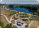 Aerial view of a park featuring walking paths, playgrounds, and a serene lake with the city skyline visible at 896 Hollywood Nw Rd, Atlanta, GA 30318