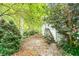 Backyard featuring a stairway, with greenery and mature trees in a peaceful setting at 970 E Main St, Canton, GA 30114