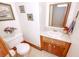 Cozy bathroom with tile floors, wooden vanity, and decorative wall art at 970 E Main St, Canton, GA 30114