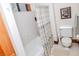 Bright bathroom featuring a white tub, patterned shower curtain, and classic framed art at 970 E Main St, Canton, GA 30114