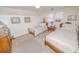 Bedroom featuring twin beds, nautical artwork, and ample dresser storage at 970 E Main St, Canton, GA 30114
