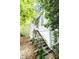 Exterior stairway leading to the home, surrounded by trees and foliage at 970 E Main St, Canton, GA 30114