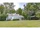 Exterior of home with a carport, surrounded by mature trees and greenery at 970 E Main St, Canton, GA 30114