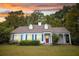 Charming single Gathering home with dormer windows, landscaping, and a red front door at 970 E Main St, Canton, GA 30114