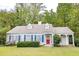 Charming home with blue shutters, red door, and lush landscaping at 970 E Main St, Canton, GA 30114