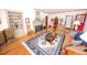 Spacious living room with hardwood floors, a fireplace, built-in shelving, and bright natural light at 970 E Main St, Canton, GA 30114