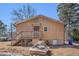 View of the back of the property with stairs leading to a small deck at 4065 Thaxton Rd, Atlanta, GA 30349
