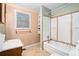 Bathroom with a sink, window, shelving and visible bathtub at 4065 Thaxton Rd, Atlanta, GA 30349