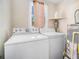 Clean laundry area featuring a washer, dryer and water heater at 4065 Thaxton Rd, Atlanta, GA 30349