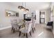 Modern dining room with glass table and stylish light fixture next to an open kitchen at 608 S Evelyn Nw Pl, Atlanta, GA 30318