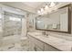 Stylish bathroom features marble counters, floors, and tub surround at 741 Bentwood Trce, Alpharetta, GA 30005