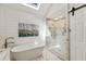 Spa-like bathroom with soaking tub, walk-in shower, shiplap walls, and natural light at 741 Bentwood Trce, Alpharetta, GA 30005