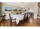 Traditional dining room with hardwood floors, chandelier, and wainscoting details at 741 Bentwood Trce, Alpharetta, GA 30005