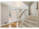 Inviting entryway with hardwood floors, staircase, and sidelight windows flanking a white front door at 741 Bentwood Trce, Alpharetta, GA 30005