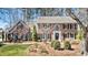 Beautiful two-story brick home with black shutters, manicured lawn, and mature trees at 741 Bentwood Trce, Alpharetta, GA 30005
