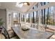 Bright sunroom with vaulted ceiling, skylight, and view of wooded backyard at 741 Bentwood Trce, Alpharetta, GA 30005