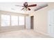 Neutral bedroom with carpet, ceiling fan, and large windows at 1378 Penhurst Dr, Lawrenceville, GA 30043