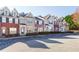Attractive townhome exteriors featuring brick and neutral siding with manicured landscaping at 1378 Penhurst Dr, Lawrenceville, GA 30043
