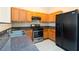 Functional kitchen with wood cabinets, dark countertops, and stainless steel appliances at 1378 Penhurst Dr, Lawrenceville, GA 30043