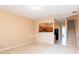 Bright living room with access to kitchen, neutral paint, carpet flooring, and staircase to upper level at 1378 Penhurst Dr, Lawrenceville, GA 30043