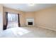 Spacious living room with fireplace, sliding glass door access to the backyard, and neutral paint at 1378 Penhurst Dr, Lawrenceville, GA 30043