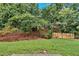 Overgrown yard with mature trees provides shade and privacy at 1573 Eastern Sunrise Ln, Decatur, GA 30034