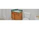 A bathroom featuring a wood vanity with green countertop and a toilet at 1573 Eastern Sunrise Ln, Decatur, GA 30034