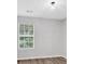 A small bedroom with a window and wood flooring at 1573 Eastern Sunrise Ln, Decatur, GA 30034