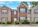 Charming brick townhome featuring black shutters, a gabled roof, and inviting curb appeal at 1573 Eastern Sunrise Ln, Decatur, GA 30034