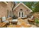 Charming stone patio with ample seating and built-in brick outdoor fireplace, perfect for entertaining at 1993 Mount Vernon Pl, Dunwoody, GA 30338