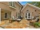 Inviting back patio features stone flooring, exterior fireplace, and comfortable seating area at 1993 Mount Vernon Pl, Dunwoody, GA 30338