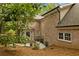 Brick home featuring backyard patio, lush trees, and manicured lawn at 1993 Mount Vernon Pl, Dunwoody, GA 30338