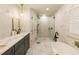 Spa-like bathroom with marble tile, soaking tub, walk-in shower, and sleek vanity at 1993 Mount Vernon Pl, Dunwoody, GA 30338