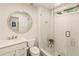Bright bathroom with a frameless glass shower, round mirror, and modern fixtures at 1993 Mount Vernon Pl, Dunwoody, GA 30338