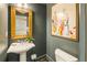Powder bathroom with dark teal walls, ornate gold mirror, and contemporary sink at 1993 Mount Vernon Pl, Dunwoody, GA 30338