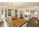 Dining area featuring a rustic wood table, chandelier, and views to the kitchen and backyard at 1993 Mount Vernon Pl, Dunwoody, GA 30338