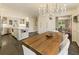Open-concept dining area with wood table, decorative chandelier, and connection to the kitchen at 1993 Mount Vernon Pl, Dunwoody, GA 30338