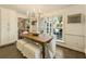 Dining room featuring a chandelier, large windows overlooking the backyard, and access to a pantry at 1993 Mount Vernon Pl, Dunwoody, GA 30338