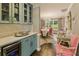 Charming dining area with light-blue cabinets, chandelier, and pink dining chairs at 1993 Mount Vernon Pl, Dunwoody, GA 30338