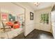 Bright entryway showcasing beautiful dark wood floors and easy access to the living room with colorful decor at 1993 Mount Vernon Pl, Dunwoody, GA 30338