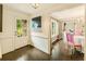 Inviting entryway features dark wood floors and access to the dining room and a glimpse of the stone exterior through the door at 1993 Mount Vernon Pl, Dunwoody, GA 30338