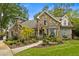 Charming stone home featuring a beautiful stone chimney, well-manicured landscaping, and a quaint front porch at 1993 Mount Vernon Pl, Dunwoody, GA 30338
