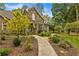 Charming stone and brick home with mature landscaping, walkway and lush green lawn at 1993 Mount Vernon Pl, Dunwoody, GA 30338