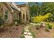 Beautiful stone and brick home with lush landscaping and flagstone walkway to entrance at 1993 Mount Vernon Pl, Dunwoody, GA 30338